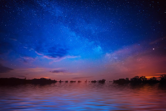 Abstract Beautiful Night Background With Blue Star Sky And Water Reflection The Lake Surface