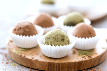 Homemade healthy vegan chocolate truffles rolled cocoa and matcha powder Horizontal photo