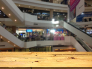 Empty wooden table space platform and blurred shopping mall background for product display montage