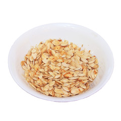 Plate with dried white sunflower seeds isolated on white background.