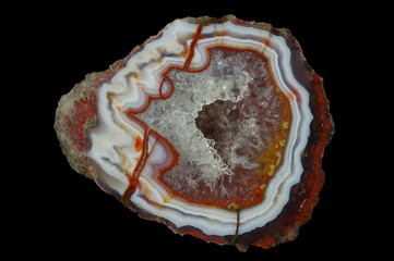 A cross section of the agate stone with quartz geode.  Multicolored silica rings colored with metal...