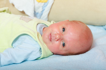 Little newborn lying calmly in blanket