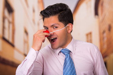 Funny businessman with red plastic nose