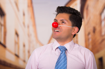Funny businessman with red plastic nose