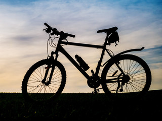 Bicycle silhouettes on the dark background of sunsets