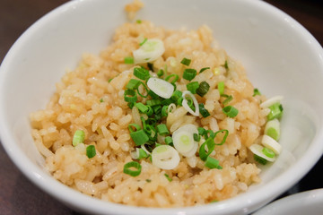Homemade garlic fried rice with mixture vegetables serve on bowl.