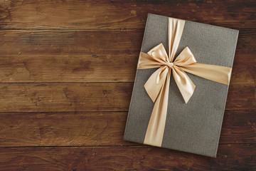 Gift box with over wooden background with copy space