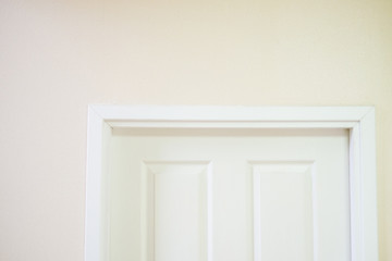 White wooden door in the white room.