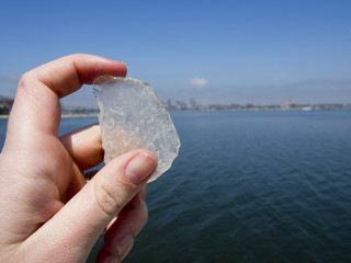 Hand Holding Up a Piece of Sea Glass