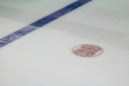 Blue line and face off spot during ice resurfacing