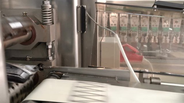 Packing of ice-cream in a wrapper. Automatic packing line of ice cream.