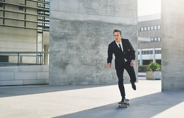 Successful businessman wearing suit riding a skateboard