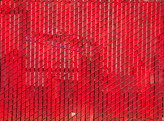 Bright red wood slats and chain link fence.
