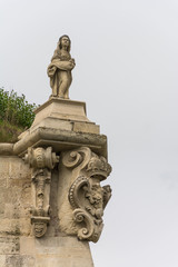 Fototapeta premium A Woman Statue Standing on the Walls of the Fortress