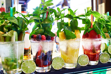 Fruit and berry cocktails with mint on cafe
