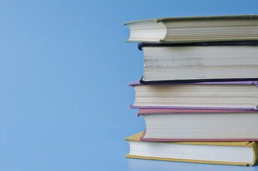 a stack of colorful books on a blue background