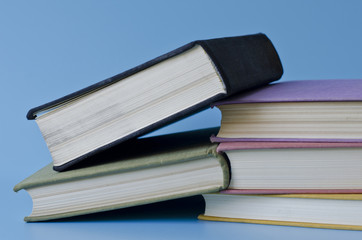 a stack of colorful books on a blue background
