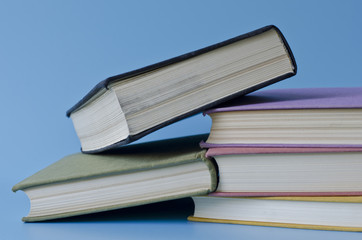 a stack of colorful books on a blue background