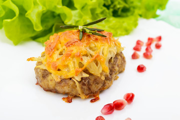 Juicy meat cutlet, baked with grated potatoes and cheese on a white ceramic plate on a light background. Close up
