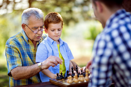 chess on a table in the park.