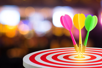 Circular target marked with numbers and dart with defocused or blurred bokeh background. An idea of...