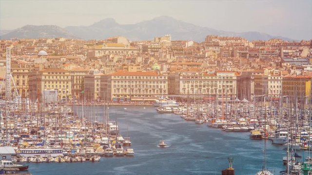 Busy Marseille bay with sail boats docked, many tourists in city, time-lapse