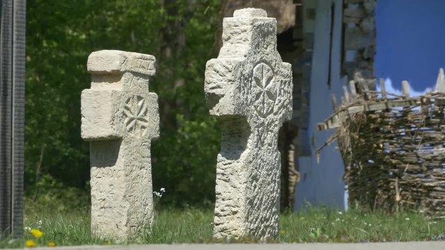 Two old stone ancient christian crosses on a rustic outdoor place.