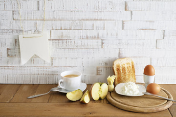 Apple quark and eggs on white wood background