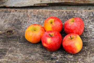 Red apples on wooden background