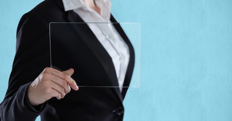 Midsection of businesswoman holding transparent device