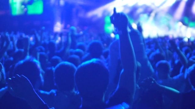 Enthusiastic audience enjoying music concert, shouting and encouraging band