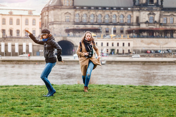Fototapeta premium Two beautiful young tourists having fun in old european town