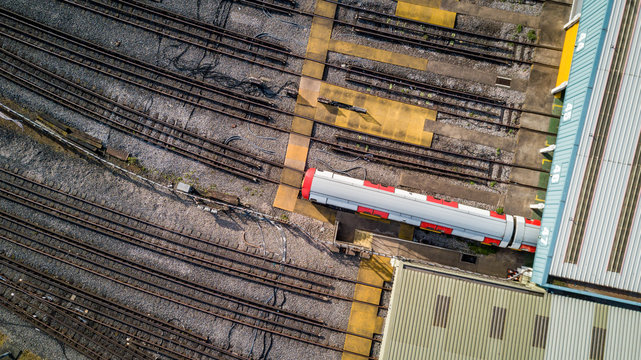 London Underground tube train depot. Aerial drone photo looking down onto a train emerging from a depot.