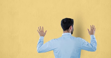 Rear view of businessman touching wall