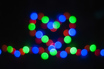 Bokeh effect on an isolated black background. Light blurs in a form of heart. Love, Christmas lights, string lights, 