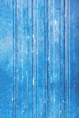 Fototapeta na wymiar Textured wooden wall, vintage dark background with a blue vignette.
