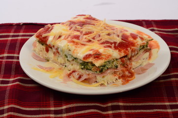 Lasaña con queso, salsa pomodoro y rellena de verdura espinaca y jamón