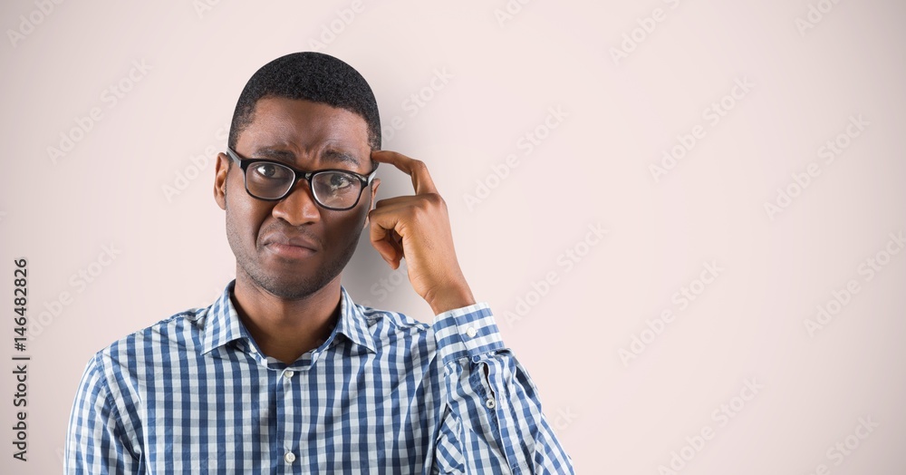 Wall mural Businessman scratching head over colored background