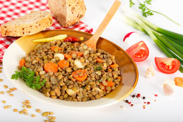 Lentil soup stew meal with lentils in a plate on white background