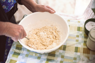 Grandmother mixing batter for pancakes