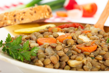Homemade Brown lentil stew with vegetable and bread. Vegetarian food.