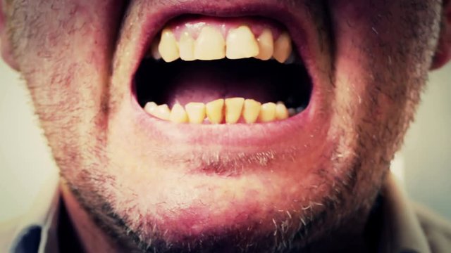 Man screaming, closeup on mouth