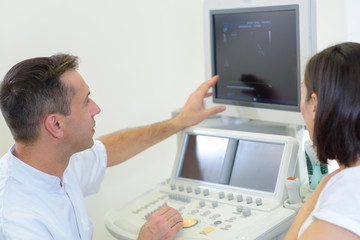 Fototapeta na wymiar Doctor showing utrasound screen to patient