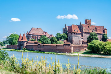 Naklejka na ściany i meble Medieval Malbork Castle in Poland, main fortress of the Teutonic Knights and the Nogat river.