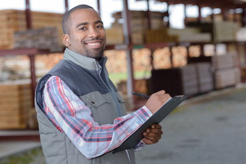 Portrait of man in wood yard