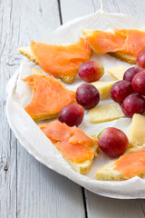 Salmon appetizer with grapes and cheese