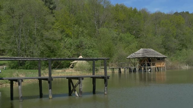 Wood old pier and lake shack on a rural area.