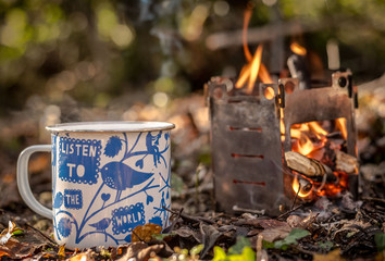 A cup of tea next to a fire