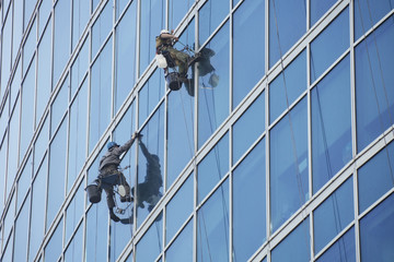 Window washers work on skyscraper, industrial alpinism