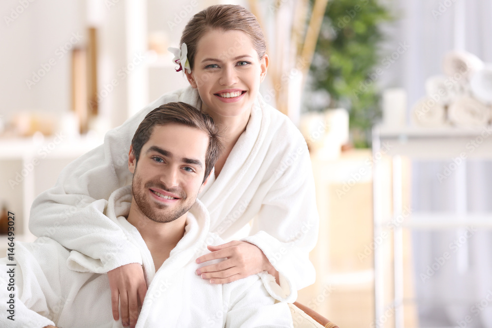 Poster Young happy couple relaxing in spa salon